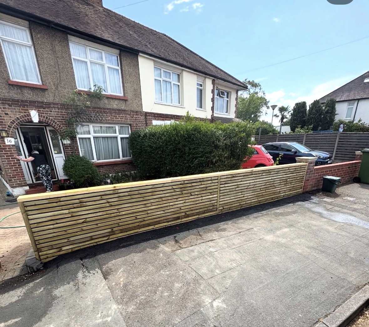 Slotted panel fence on concrete posts